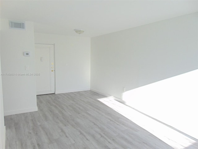 spare room with light hardwood / wood-style floors