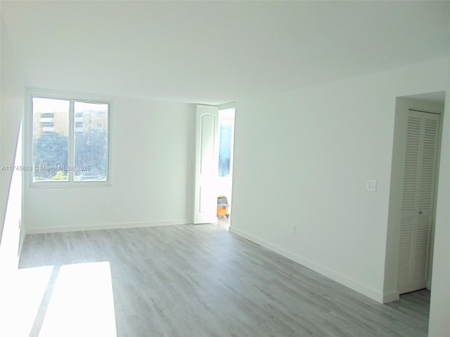 empty room with light hardwood / wood-style flooring