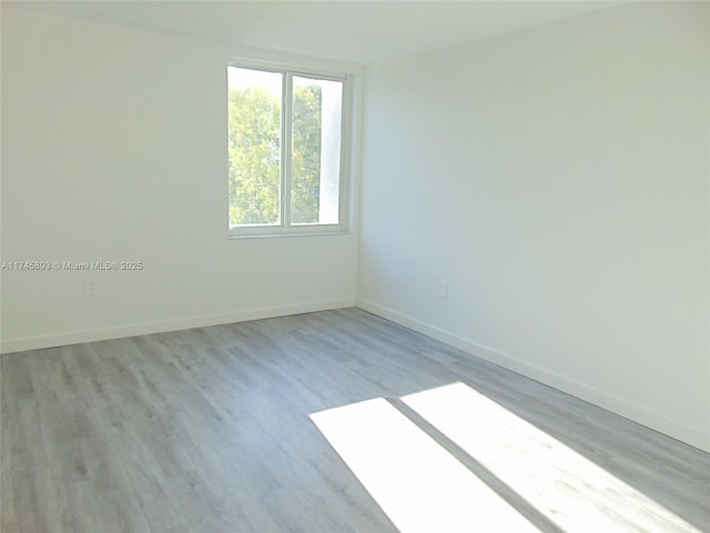 empty room with light hardwood / wood-style floors