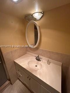 bathroom with vanity, tile walls, and tile patterned floors