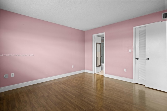 2811 N Pine Island Rd Unit 302, Sunrise, FL 33322 - spare room featuring a textured ceiling, baseboards, visible vents, and wood finished floors