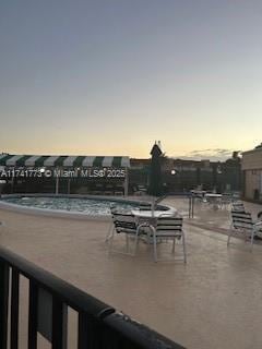 view of patio terrace at dusk