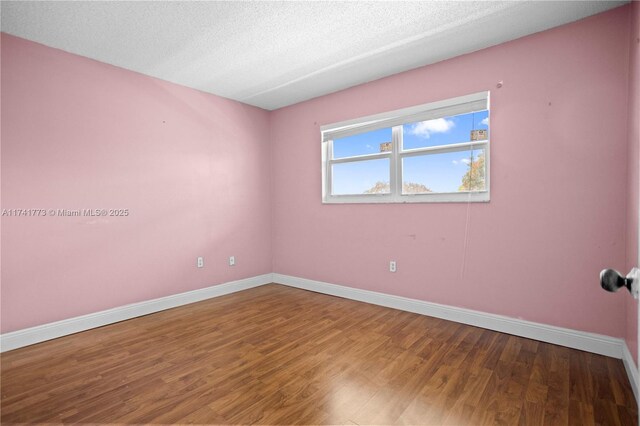 2811 N Pine Island Rd Unit 302, Sunrise, FL 33322 - unfurnished room featuring a textured ceiling, baseboards, and wood finished floors