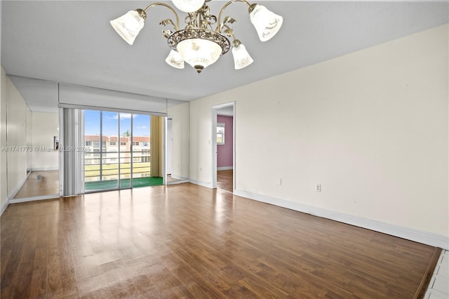 2811 N Pine Island Rd Unit 302, Sunrise, FL 33322 - spare room featuring an inviting chandelier, baseboards, wood finished floors, and expansive windows