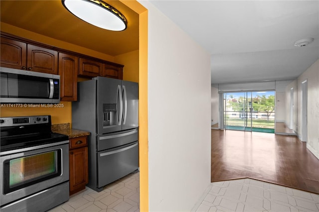 2811 N Pine Island Rd Unit 302, Sunrise, FL 33322 - kitchen featuring dark stone counters, appliances with stainless steel finishes, and open floor plan
