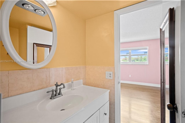 2811 N Pine Island Rd Unit 302, Sunrise, FL 33322 - bathroom with vanity, wood finished floors, and tile walls