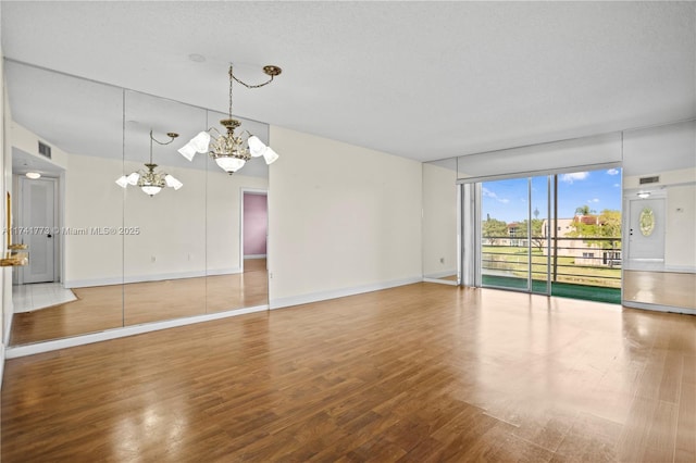 2811 N Pine Island Rd Unit 302, Sunrise, FL 33322 - interior space with baseboards, a notable chandelier, wood finished floors, and visible vents