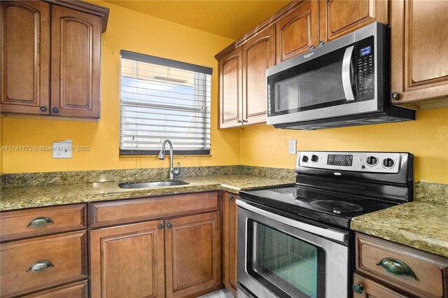 2811 N Pine Island Rd Unit 302, Sunrise, FL 33322 - kitchen featuring brown cabinetry, a sink, and stainless steel appliances