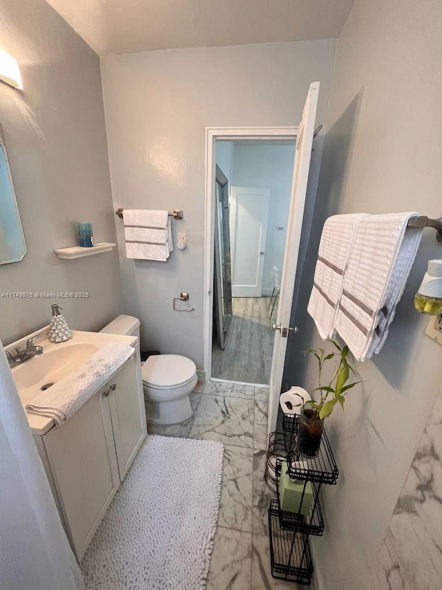 bathroom featuring vanity and toilet