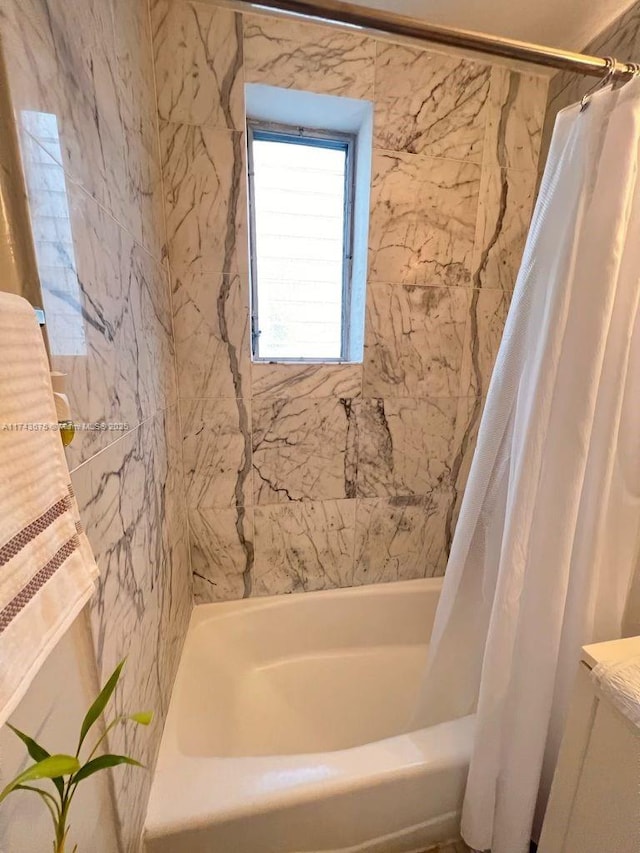 bathroom with shower / bath combination with curtain