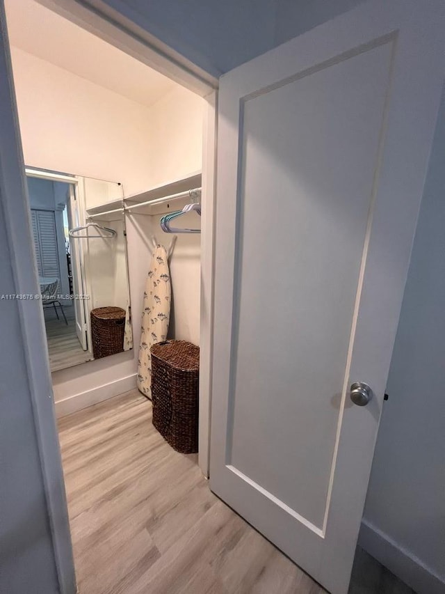 walk in closet featuring light hardwood / wood-style flooring