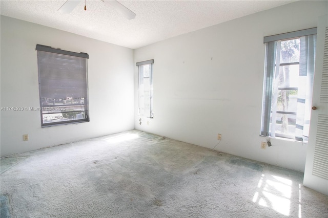 7511 S Oriole Blvd Unit 201, Delray Beach, FL 33446 - carpeted empty room with plenty of natural light, ceiling fan, and a textured ceiling