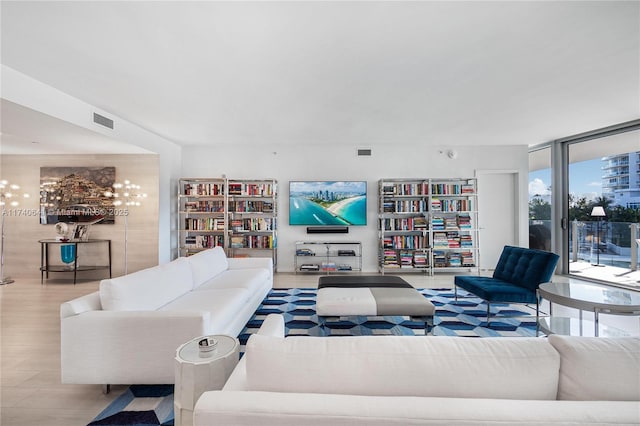 living room featuring floor to ceiling windows and light hardwood / wood-style floors