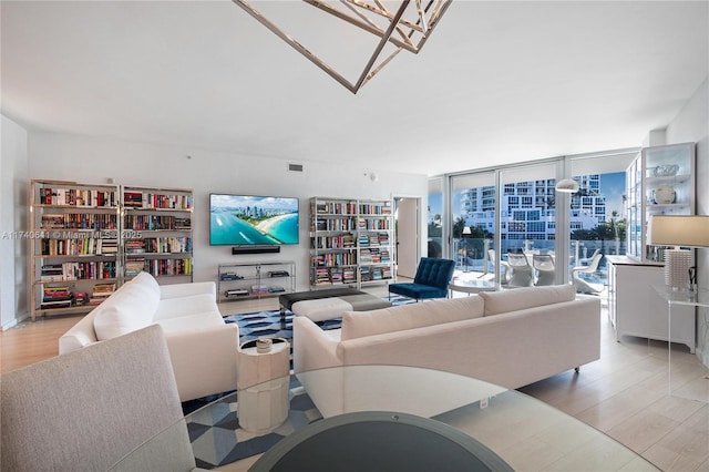 living room featuring light hardwood / wood-style floors and floor to ceiling windows