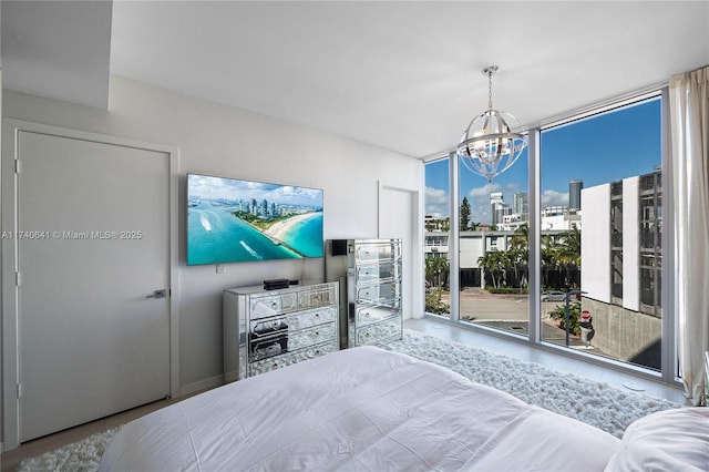 bedroom featuring floor to ceiling windows, access to outside, and an inviting chandelier