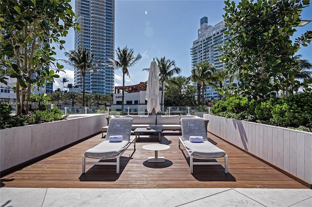 wooden terrace featuring an outdoor living space