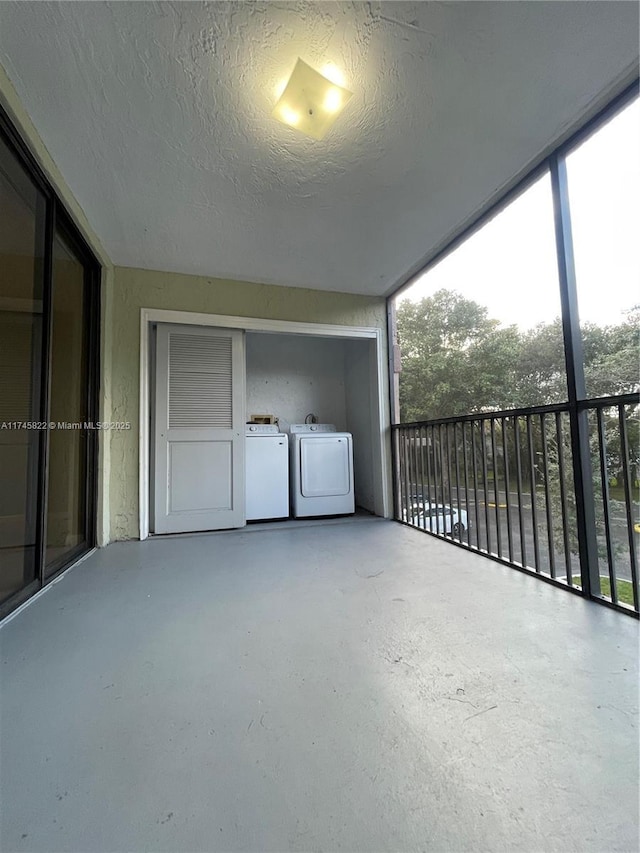 view of patio / terrace with a balcony and washer and dryer