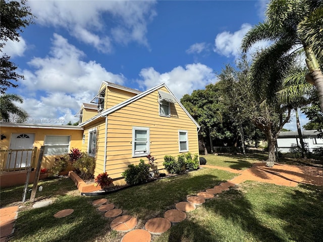 view of property exterior featuring a lawn