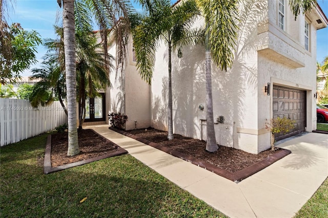 exterior space featuring a garage and a yard