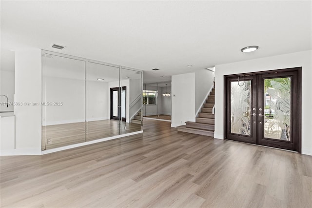 17356 SW 21st St, Miramar, FL 33029 - entryway with stairs, french doors, light wood-style flooring, and baseboards