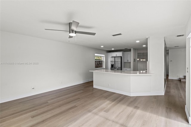 17356 SW 21st St, Miramar, FL 33029 - unfurnished living room featuring light wood-type flooring, recessed lighting, ceiling fan, baseboards, and a sink