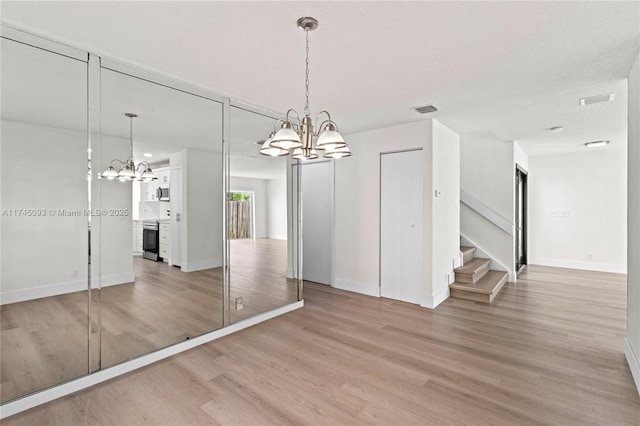 17356 SW 21st St, Miramar, FL 33029 - unfurnished dining area with a chandelier, light wood-style floors, and stairway