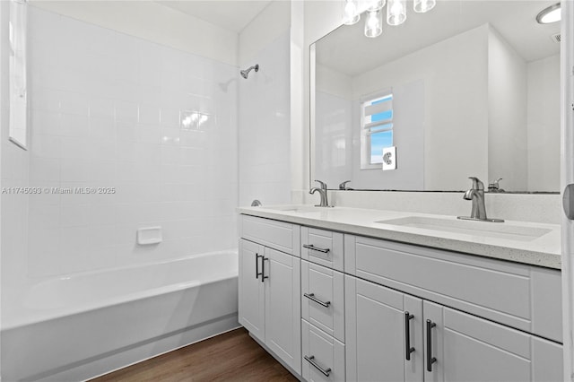 bathroom with vanity, hardwood / wood-style flooring, and tiled shower / bath combo