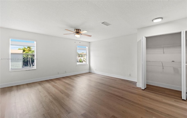 17356 SW 21st St, Miramar, FL 33029 - unfurnished bedroom with wood finished floors, a textured ceiling, baseboards, ceiling fan, and a closet