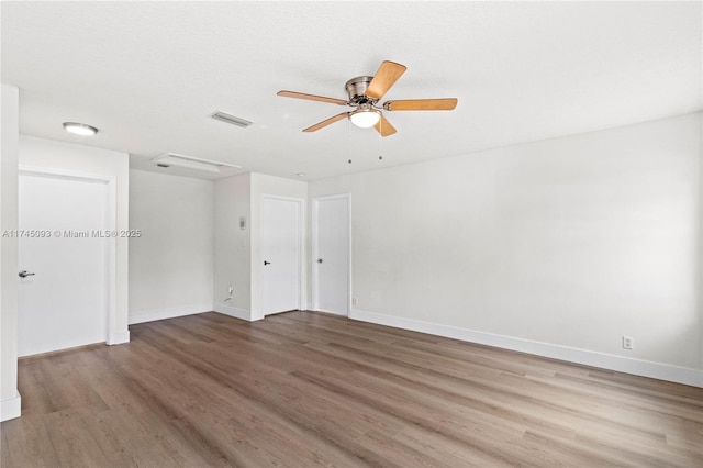 unfurnished room with hardwood / wood-style flooring and ceiling fan