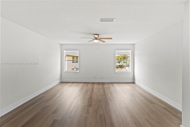 17356 SW 21st St, Miramar, FL 33029 - spare room with wood finished floors, ceiling fan, plenty of natural light, and a textured ceiling