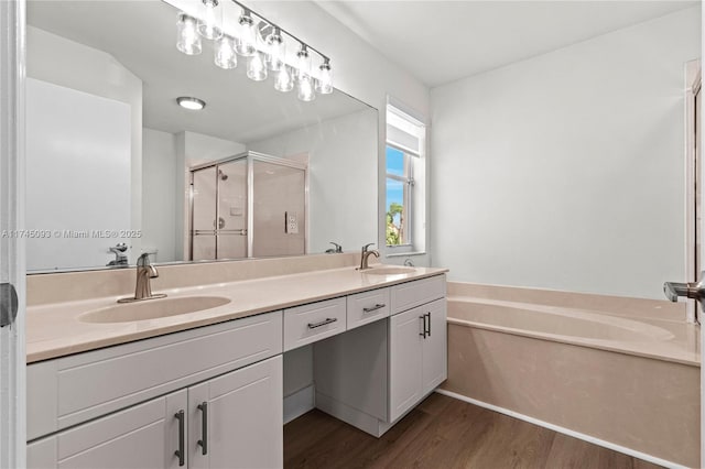 bathroom featuring vanity, hardwood / wood-style floors, and shower with separate bathtub