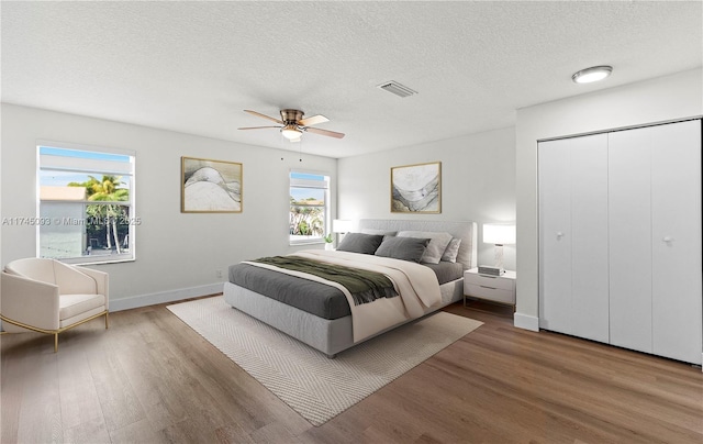 17356 SW 21st St, Miramar, FL 33029 - bedroom with wood finished floors, a textured ceiling, ceiling fan, and a closet