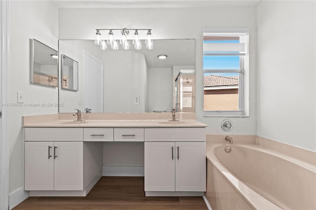 17356 SW 21st St, Miramar, FL 33029 - bathroom featuring double vanity, a bath, and wood finished floors