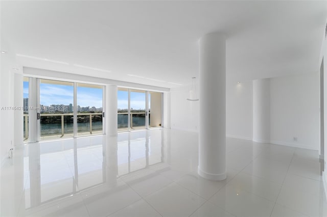 tiled spare room with a water view