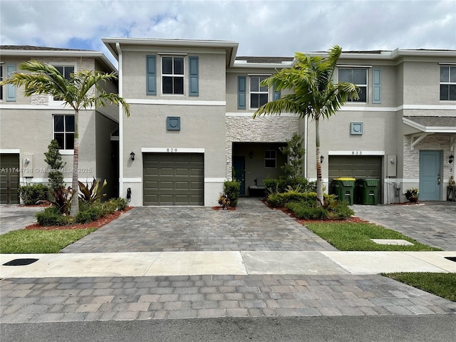 townhome / multi-family property featuring a garage