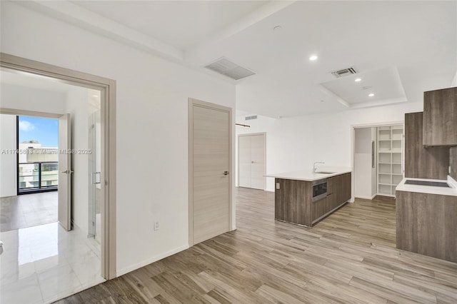 kitchen with sink and light hardwood / wood-style flooring