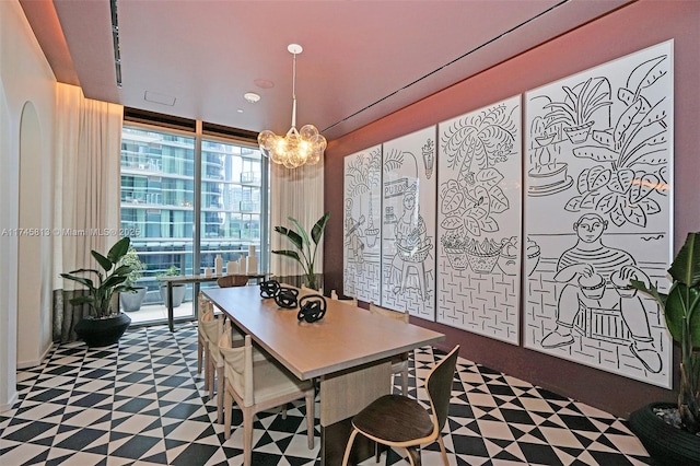 dining room with floor to ceiling windows and a chandelier