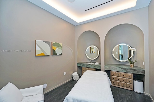 bedroom with sink and dark hardwood / wood-style floors