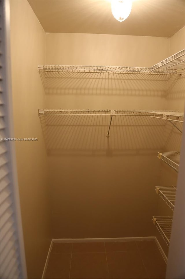 spacious closet with tile patterned floors