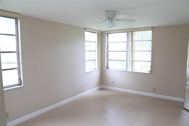 spare room featuring light tile patterned flooring and ceiling fan