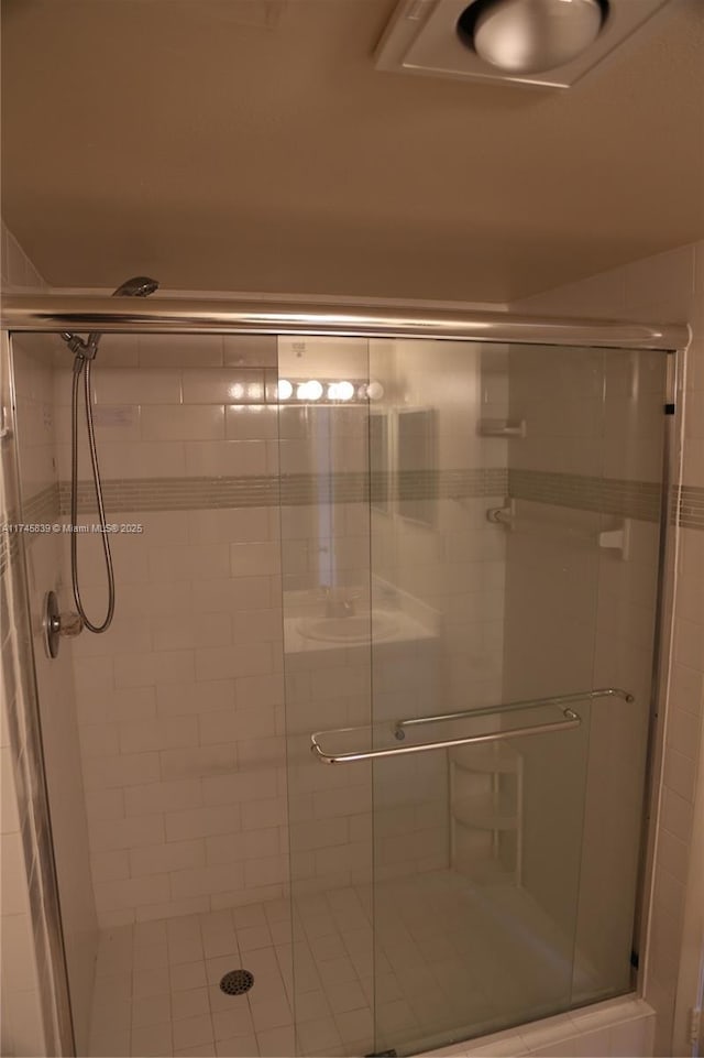 bathroom with a shower with door