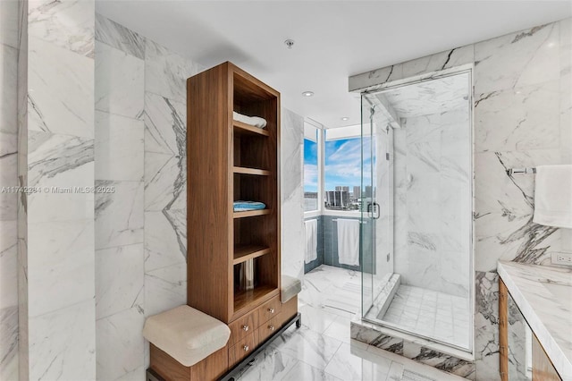 bathroom with stone wall, recessed lighting, vanity, marble finish floor, and a marble finish shower