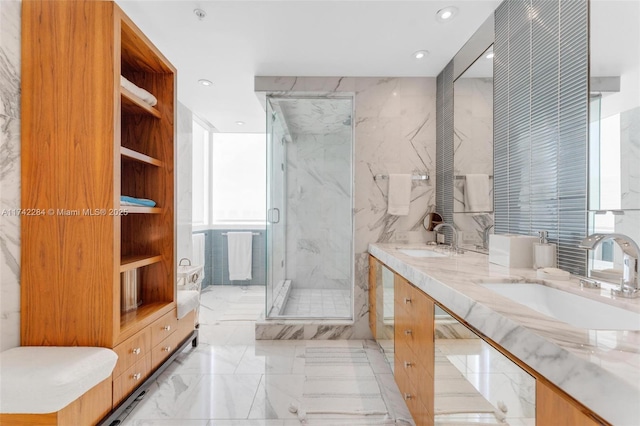 bathroom featuring marble finish floor, a sink, a marble finish shower, and double vanity