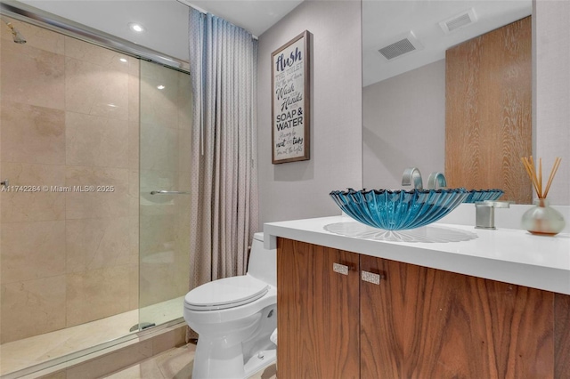 full bath with a shower stall, visible vents, vanity, and toilet