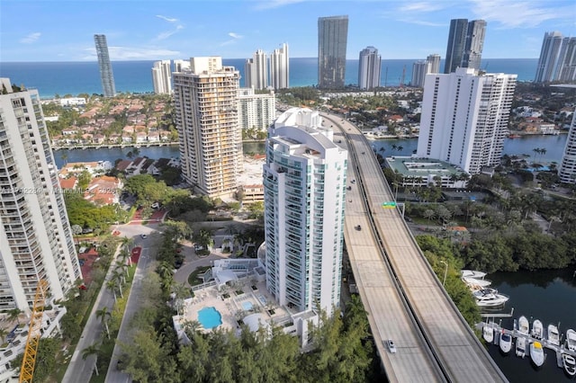 birds eye view of property with a view of city and a water view