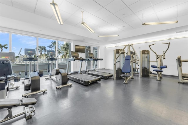 exercise room with a drop ceiling and visible vents