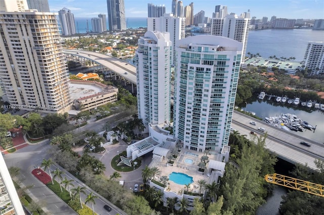 drone / aerial view featuring a water view and a view of city