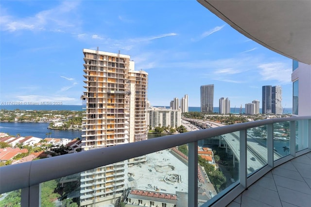 balcony with a view of city and a water view