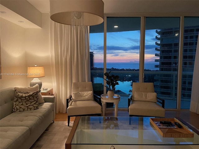 living area with floor to ceiling windows and a water view