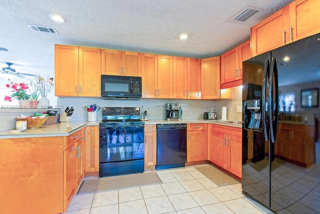 kitchen featuring a ceiling fan, black appliances, light countertops, and visible vents